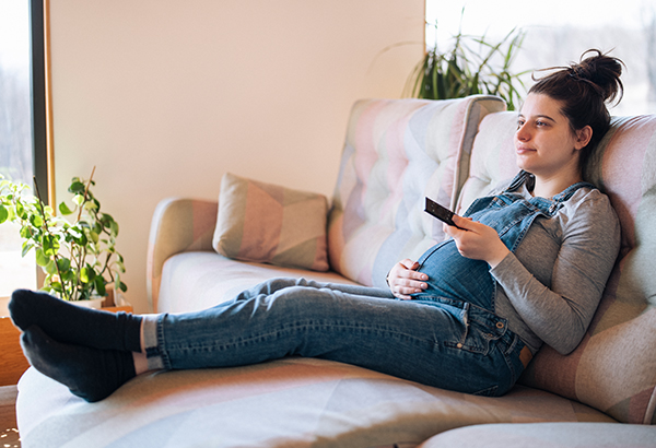 woman on couch watching tv