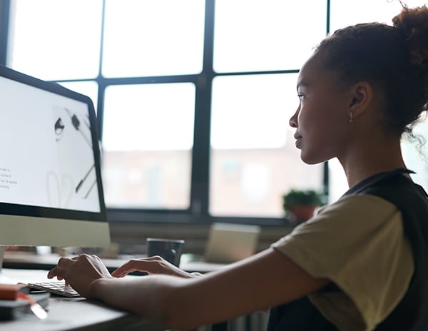 woman using desktop computer