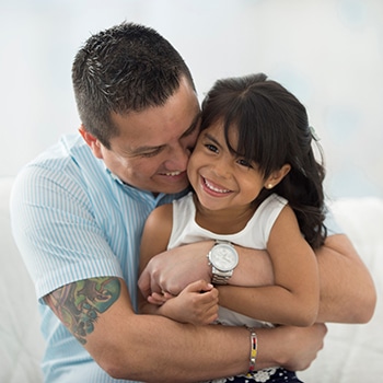 a man hugging his daughter