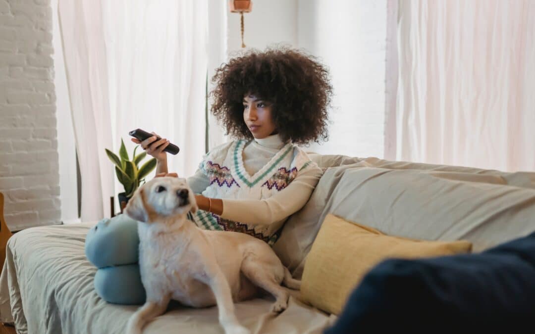 woman and dog watching cable tv
