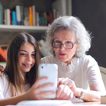 woman and girl using a phone